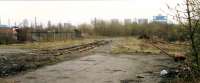 Flemington Coal Yard. Ahead the line ran to Shieldmuir. The bridge has been removed. In the background from left to right is Ravenscraig.<br><br>[Ewan Crawford //1988]