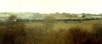 Reaching the end of its journey are a pair of 37s and coal train from Hunterston. Beyond the locomotives are the mounds of slag for reprocessing.<br><br>[Ewan Crawford //1988]