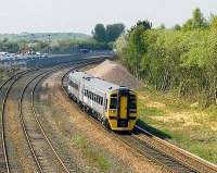 The 1355 service to Newcraighall photographed passing a pile of ballast shortly after leaving Bathgate on 13 May. Clearance of trees, delivery of sleepers and two sets of made-up points in the nearby yard provide further clues regarding the proximity of the works team. <br>
<br><br>[James Young 13/05/2008]