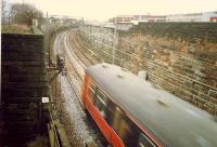 Westbound 303 passes over the former Glasgow Central Railway and climbs to Yorkhill. Goods yards stood to either side of the line here.<br><br>[Ewan Crawford //1988]