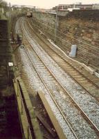 Eastbound 303 approaches the bridge over the former Glasgow Central Railway. Goods yards stood to either side of the line here.<br><br>[Ewan Crawford //1988]