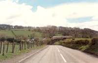 Looking south at what was a railway bridge crossing the road near Twechar. The line was Bairds of Gartshores private line to coalmines by Kilsyth. Little remains of it today.<br><br>[Ewan Crawford //1990]