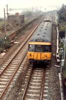 The driver of 303 006 goes for a walk in the cab. Eastbound passing under the Lanarkshire and Dumbartonshire bridge at Bowling.<br><br>[Ewan Crawford //1990]