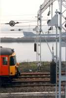 Eastbound 303 passes eastbound ship at Bowling Harbour. Nice tensioners on the catenary.<br><br>[Ewan Crawford //1990]