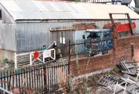 The line is effectively closed while the level crossing gates are opened to let an Arnott Young truck into the yard on the sea side of the railway. Access by kind permission of British Rail.<br>
<br>
The shed seen here was full of traction engines.<br><br>[Ewan Crawford //1990]