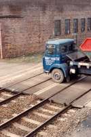 The line is effectively closed while an Arnott Young truck crosses the railway to reach the yard on the sea side of the railway. Access by kind permission of British Rail.<br><br>[Ewan Crawford //1990]