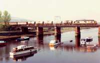 Afternoon Fort William-Mossend freight crosses the River Leven just west of Dumbarton Central.<br><br>[Ewan Crawford //1990]