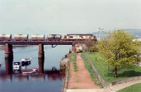 In sweltering heat the afternoon Fort William-Mossend freight crosses the River Leven just west of Dumbarton Central.<br><br>[Ewan Crawford //1990]