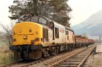 37 403 dropping off an empty timber train into Crianlarich Lower in 1990. The line here is now closed and lifted.<br><br>[Ewan Crawford //1990]