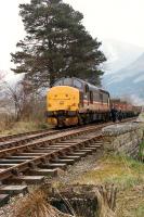 37 405 arrives from Oban to take the timber train west to Oban. Note the base of a signalpost in the foreground.<br><br>[Ewan Crawford //1990]