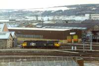 A pair of 47s rest outside the locomotive works at Inverness. Beyond is the carriage maintenance shed and carriage shed.<br><br>[Ewan Crawford //]