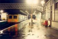 DMU about to head south at Stirling. Note lights in distant Stirling Middle box.<br><br>[Ewan Crawford 27/11/1988]