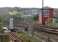 Looking south over Larbert Junction in April 2006. The Edinburgh line turns off to the left towards Carmuirs East Junction, while the Glasgow line continues down the bank past Carmuirs West box (in the distance) before passing below the Forth and Clyde Canal. The Falkirk Wheel dominates the background.<br><br>[John Furnevel 26/04/2006]