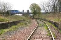 Looking east from Kincardine station in April 2006 as the line runs under the northern approach to the Kincardine Bridge with Longannet power station just beyond. Coal trains which now reach Longannet from the east via the Forth Bridge will be switched to this route on reopening of the line in early 2008. [See image 18553]<br><br>[John Furnevel 19/04/2006]