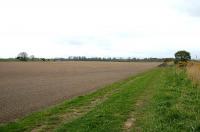 Looking across acres of ploughed field (well..a lot) in April 2006 at the embankment running south to Alloa swing bridge (far left). The public path ends at the pile of earth by the tree on the right and to the right of that is the raised dyke. <br><br>[John Furnevel 27/04/2006]