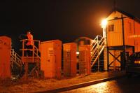 Ready with the hoop for a westbound train at Forres (blurred, by box). Just a few lineside cabinets.<br><br>[Ewan Crawford //]