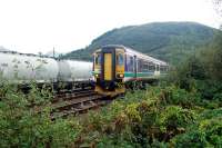 Sprinter passing bauxite wagons in Fort William Junction yard.<br><br>[Ewan Crawford //]