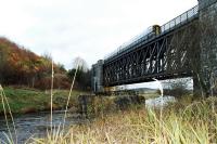 Inverness bound train crossing the viaduct between Avochie and Rothiemay. The remains of the old viaduct can be seen in the foreground.<br><br>[Ewan Crawford //]