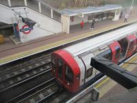 <h4><a href='/locations/W/West_Acton'>West Acton</a></h4><p><small><a href='/companies/E/Ealing_and_Shepherds_Bush_Railway'>Ealing and Shepherd's Bush Railway</a></small></p><p>LUL 1992 stock with a Central Line train to Ealing Broadway calling at its penultimate stop at West Acton, seen from stairwell to westbound platform, on 9th February 2019.   This section of the Central Line was promoted by the GWR as the Ealing & Shepherd's Bush Railway but GWR trains never ran, instead Central Line trains were extended over the line from the 1908 terminus at Wood Lane (replaced by White City in 1947) to Ealing Broadway in 1920.  East Acton was originally the only intermediate station but North Acton and West Acton were added in 1923.   The branch from North Acton to West Ruislip (originally intended to continue to Denham with an intermediate station at South Harefield), was part of the LPTB's 1935 New Works programme, delayed by World War Two, eventually opened in stages in 1947/48. 23/30</p><p>09/02/2019<br><small><a href='/contributors/David_Bosher'>David Bosher</a></small></p>