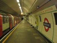 <h4><a href='/locations/W/Wanstead'>Wanstead</a></h4><p><small><a href='/companies/C/Central_Line_Extension_London_Passenger_Transport_Board'>Central Line Extension (London Passenger Transport Board)</a></small></p><p>LUL 1992 stock on a Central Line short working to Newbury Park arriving at Wanstead station, east London, on the afternoon of Saturday, 5th January 2013.   The eastern end of the Central Line, from a point just west of Leyton, runs over the former GER Loughton and Epping line as well as most of the Woodford to Ilford section of the Hainault Loop.   The new tunnel linking Leytonstone with Newbury Park was complete before World War Two but then the scheme went into abeyance for the duration and the three miles of tunnel were converted into a secret underground factory for the manufacturing of air components by the Plessey Company.    A narrow gauge railway was also completed.  After the war, everything had to be removed and it was not until 14th December 1947 that Central Line trains first ran through the tunnels.   Still, better late than never, the proposed similar electrification of the ex-GNR Alexandra Palace branch in north London as part of the LUL Northern Line, likewise begun before 1939, was never completed after 1945 and the line closed in 1954, leaving residents of Crouch End and Muswell Hill dependant only on buses ever since. 4/30</p><p>05/01/2013<br><small><a href='/contributors/David_Bosher'>David Bosher</a></small></p>