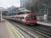 <h4><a href='/locations/N/North_Acton'>North Acton</a></h4><p><small><a href='/companies/E/Ealing_and_Shepherds_Bush_Railway'>Ealing and Shepherd's Bush Railway</a></small></p><p>LUL 1992 Central Line train to Ealing Broadway arriving at North Acton (opened 1923) on 9th February 2019. Though the Ealing & Shepherd's Bush Railway was opened by the GWR in 1920, the Central London Railway (renamed Central Line in 1937) always provided the passenger service.The line was quadrupled in 1937 between North Acton and the point where the Central Line trains joined from Wood Lane (replaced by White City in 1947) with the extra tracks being used to segregate freight trains to and from the West London Line from the tube trains. The freight trains ceased in 1964 and the 1937 tracks were lifted with the junction north of the former Uxbridge Road station severed. Today, while there is still evidence of the extra tracks between North and East Acton, at White City new buildings and roads have completely obscured the link to, and junction with, the West London Line.  (For further details of the Ealing & Shepherd's Bush line, see my photo of West Acton (image no. 80248). 22/30</p><p>09/02/2019<br><small><a href='/contributors/David_Bosher'>David Bosher</a></small></p>