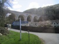 <h4><a href='/locations/C/Chelfham_Viaduct'>Chelfham Viaduct</a></h4><p><small><a href='/companies/L/Lynton_and_Barnstaple_Railway'>Lynton and Barnstaple Railway</a></small></p><p>Majestic, but silent since 1935 when the Lynton & Barnstaple Railway closed, Chelfham Viaduct is ready for narrow gauge trains again although it will still be some years before they cross. This view is from one of the buses taking UK Railtours' day-trippers from Barnstaple station to the revived section of the L & B at Woody Bay, on 17th April 2016. 9/46</p><p>17/04/2016<br><small><a href='/contributors/David_Bosher'>David Bosher</a></small></p>