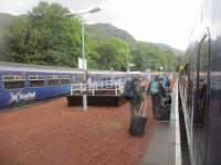 <h4><a href='/locations/A/Ardlui'>Ardlui</a></h4><p><small><a href='/companies/W/West_Highland_Railway'>West Highland Railway</a></small></p><p>Ardlui station at the north end of Loch Lomond, looking north, with passengers alighting from the Mallaig portion of the ex-12.22 service from Glasgow Queen Street (with the Oban portion being detached at Crianlarich) on Wednesday, 7th September 2022. On the left is a southbound service to Glasgow Queen Street; contrary to the normal British rule of passing on the left at stations on single track lines with passing loops, these trains unusually, are here crossing on the right. 3/18</p><p>07/09/2022<br><small><a href='/contributors/David_Bosher'>David Bosher</a></small></p>