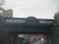 <h4><a href='/locations/E/Earlsfield'>Earlsfield</a></h4><p><small><a href='/companies/L/London_and_Southampton_Railway'>London and Southampton Railway</a></small></p><p>The bridge over Garratt Lane at Earlsfield, south London, looking south from the front upstairs windows of an EH type bus on TfL route 77 from Waterloo to Tooting station, on the afternoon of Saturday, 19th November 2022. This line was opened by the London & Southampton Railway in 1838 but Earlsfield station (on left), between Clapham Junction and Wimbledon, was not opened until 1st April 1884 by the London & South Western Railway. 174/189</p><p>19/11/2022<br><small><a href='/contributors/David_Bosher'>David Bosher</a></small></p>