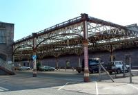 Its not unusual to see stations converted into carparks, on this occasion even when the station is still open. Cars sit in the cut-back northbound bay platforms.<br><br>[Ewan Crawford 13/07/2003]