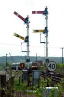 A train for Edinburgh passes a train from Glasgow by Larbert Junction box.<br><br>[Ewan Crawford 06/05/2006]