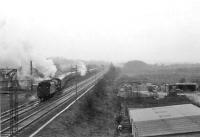 Looking south from Muirend station on a wet Saturday 11 April 1964 as Black 5s 44899 and 44979 store the empty stock of football specials on the Muirend to Clarkston East spur.<br><br>[John Robin 11/04/1964]