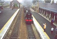 A member of the footplate crew of B1 61264 about to collect the token from the signal lady at Nairn in 2000. The goods shed on the upper left has since been dismantled and moved to Bridge of Dun.<br><br>[John Gray /09/2000]