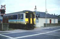 A sprinter at the main level crossing at Dingwall. The crossing is ungated and there have, unfortunately, been some meetings of trains and cars.<br><br>[John Gray //]