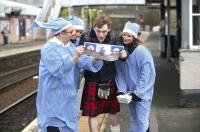 Willie Cowan (ScotRail staff member at Inverkeithing Station)<br>
joined promotional team members, Kerry-Ann Quinn (left) and Dannine<br>
Stenhouse (right) on 9 March to tell passenger, Fraser Littlejohn, about the<br>
Caledonian Sleeper service.<br><br>[ScotRail 09/03/2012]