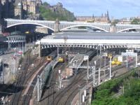 Sunday morning at the east end of Waverley on 28 May 2006. On the right work continues on the new northside through platform while on the left at the end of the car park the IECC extension to the Edinburgh Signalling Centre is well underway [see image 12571]. Ironic perhaps that, in this classic North British scene, beyond the station's glass roof, over the North Bridge and below Edinburgh Castle, the Caledonian Hotel occupies centre stage.<br><br>[John Furnevel 28/05/2006]