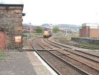 67007 going south through Dalwhinnie with four utility vans.The crossing in the foreground leads to the signal box which is hidden behind the old water tower base.31/05/06.<br><br>[John Gray 31/05/2006]