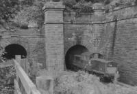 Clayton D8507 leaves Inverkip tunnel with Wemyss Bay train.<br><br>[John Robin 13/08/1963]
