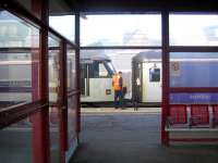 View from the waiting room at Carstairs on 6 June 2006. 90027 is in the process of coupling up to the rear of the Lowland Sleeper, 7 coaches of which it will take on to Edinburgh Waverley, while the front 8 continue to Glasgow Central.<br><br>[John Furnevel 06/06/2006]