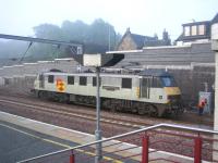 Early shift. Waiting at Carstairs on 6 June 2006 for the arrival of the combined Edinburgh/Glasgow Sleeper from Euston is 90027. Following the split, the locomotive will take the rear portion on to Waverley.<br><br>[John Furnevel 06/06/2006]