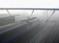 <h4><a href='/locations/C/Carstairs'>Carstairs</a></h4><p><small><a href='/companies/C/Caledonian_Railway'>Caledonian Railway</a></small></p><p>The Edinburgh portion of the Lowland Sleeper held in the mist at Carstairs at 0640 on 6 June 2006 as the 0550 Glasgow - London Pendolino service passes through at speed on the adjacent platform... honest. 22/42</p><p>06/06/2006<br><small><a href='/contributors/John_Furnevel'>John Furnevel</a></small></p>