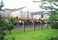 EWS 66108 with a PW train just west of Haymarket station on Sunday morning 4 June 2006. Arc lights have been rigged along the fence in connection with work on the approach to the new platform zero.<br><br>[John Furnevel 04/06/2006]