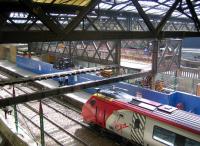 Scene at Waverley on 8 June 2006 showing the old footbridge across platform 19 linking the station walkway with Waverley Steps and Princes Street with the deck now removed. A temporary bridge has been installed during the works providing access via the Princes Mall shopping centre [see image 9657]. <br><br>[John Furnevel 08/06/2006]