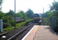 A Drumgelloch - Helensburgh train approaching Airdrie out of the sun over the bridge immediately east of the station over the B802 Broomknoll Street that once carried the former double track route to Bathgate. June 2006.<br><br>[John Furnevel 11/06/2006]