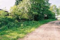 Kirkbank Station goods dock is largely obscured by trees. Looking towards Roxburgh.<br><br>[Clive Barlow 25/05/2006]