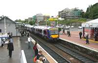 The station clock shows 7.30am as a northbound Fife Circle train arrives at Inverkeithing on a dull and drizzly Monday morning in June 2006. On the southbound platform commuters are starting to gather for the next train into Edinburgh.<br><br>[John Furnevel 19/06/2006]