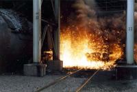 Molten iron discharges into a torpedo as a blast furnace is tapped at Ravenscraig. A bit warm for photographs.<br><br>[Ewan Crawford //1988]