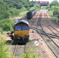 Having run round its train, EWS 66207 prepares to reverse back and couple up in Halbeath sidings before heading for Longannet. The bridge in the background carries the M90 motorway.<br><br>[John Furnevel 13/06/2006]