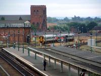 A Sprinter leaving Shrewsbury in the summer of 2006 passes the box with the biggest lever frame left on Network Rail.<br><br>[Ewan Crawford 10/07/2006]