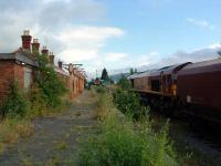 Stand-off at Aberdare High Level ... the coal train serves the loading facility for the Tower Colliery near Hirwaun and the Sprinter is terminating on a local service from Cardiff.<br><br>[Ewan Crawford 06/07/2006]