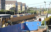 View west over the car park at a closed Haymarket station on Sunday 16 July 2006, with Haymarket East Junction in the background. A PW train stands in platform 2 as work continues on the track layout and the new bay platform, the side wall of which can be seen above the blue doors. <br><br>[John Furnevel 16/07/2006]